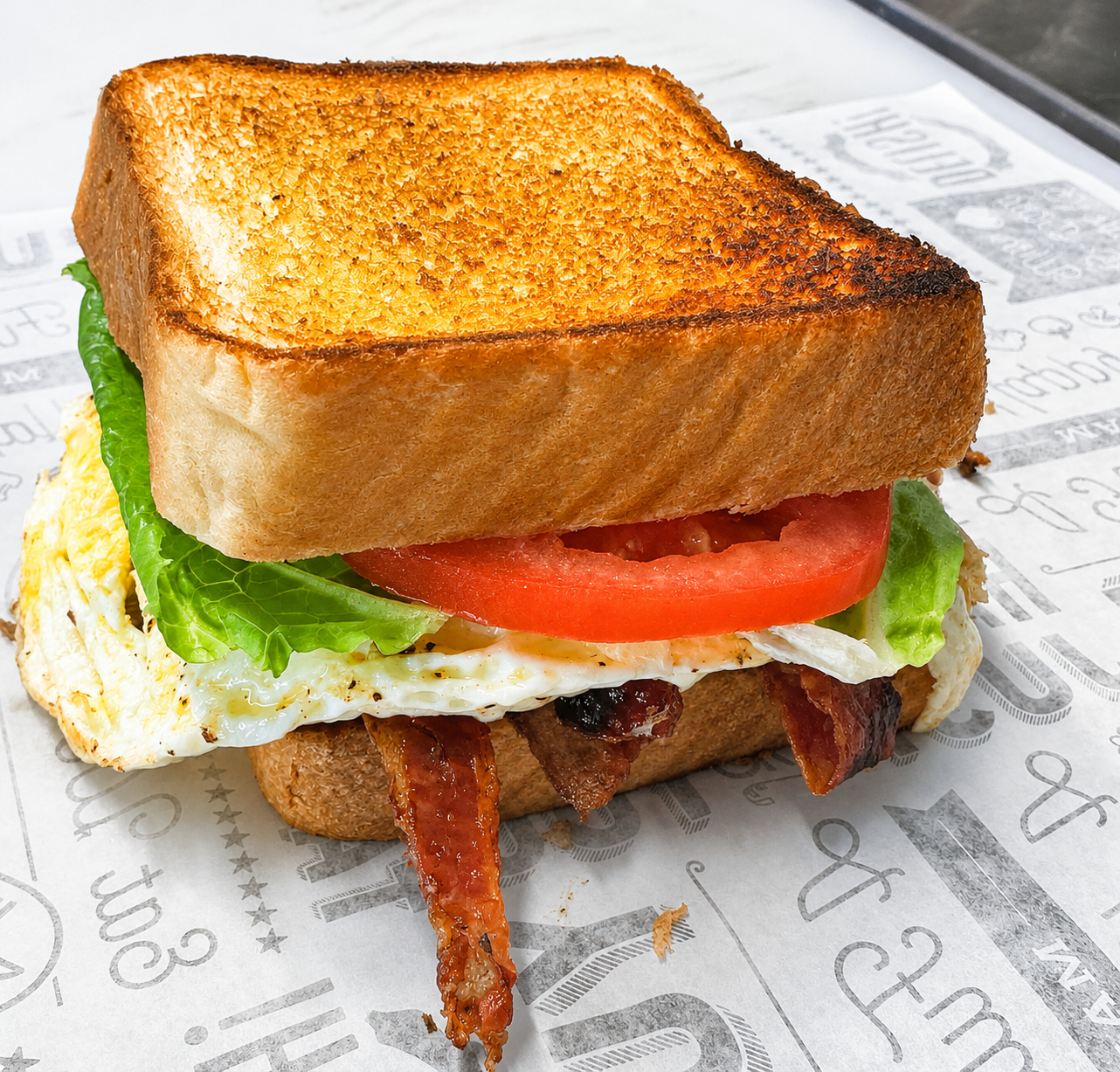 Eve's Garden Deli signature BLT with egg on golden toasted brioche